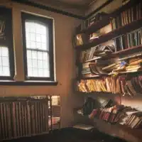 Old office shelves collapsing under piles of disorganised paper files.